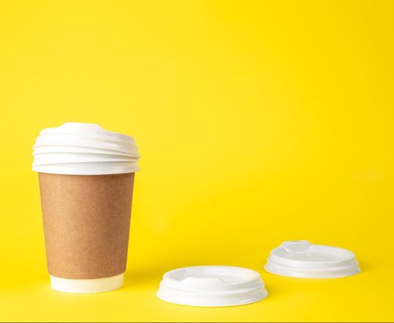 paper-cup-plastic-lids-yellow-background-isolated